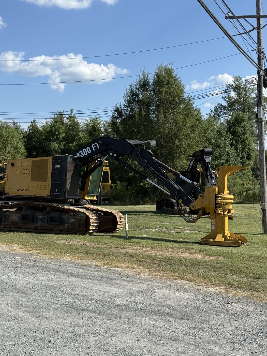 Track feller buncher with 300 FT boom in the yard
