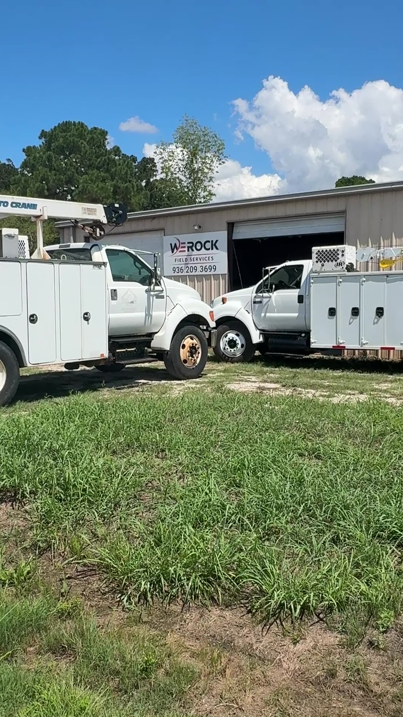 We Rock Fleet Services crane-body service trucks lined up at the shop