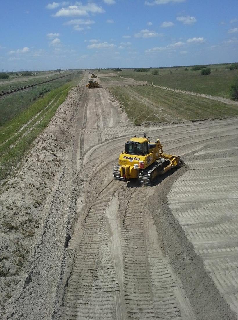 Dozer grading right-of-way next to railroad