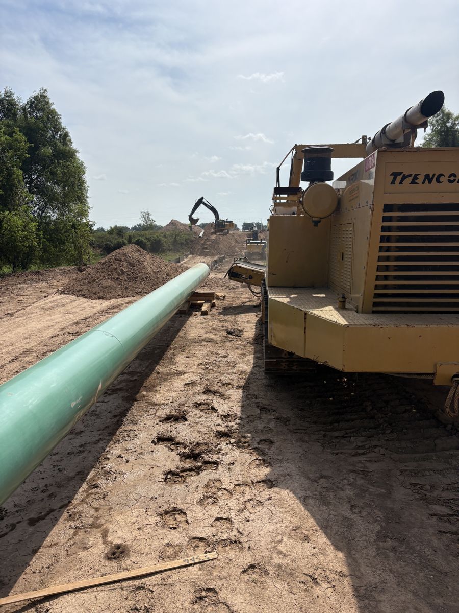 Trencor beside strung pipe